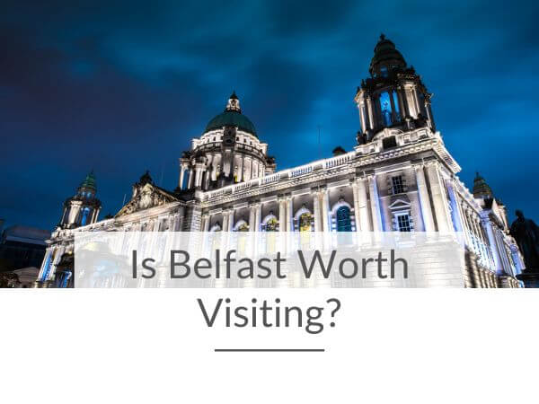 A picture of Belfast City Hall by night with text overlay saying is Belfast worth visiting.