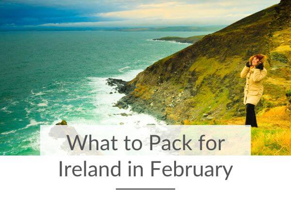 A picture of a lady in a beige winter coat with fur trim on the hood, standing on a grass bank at the coast and text overlay saying what to pack for Ireland in February