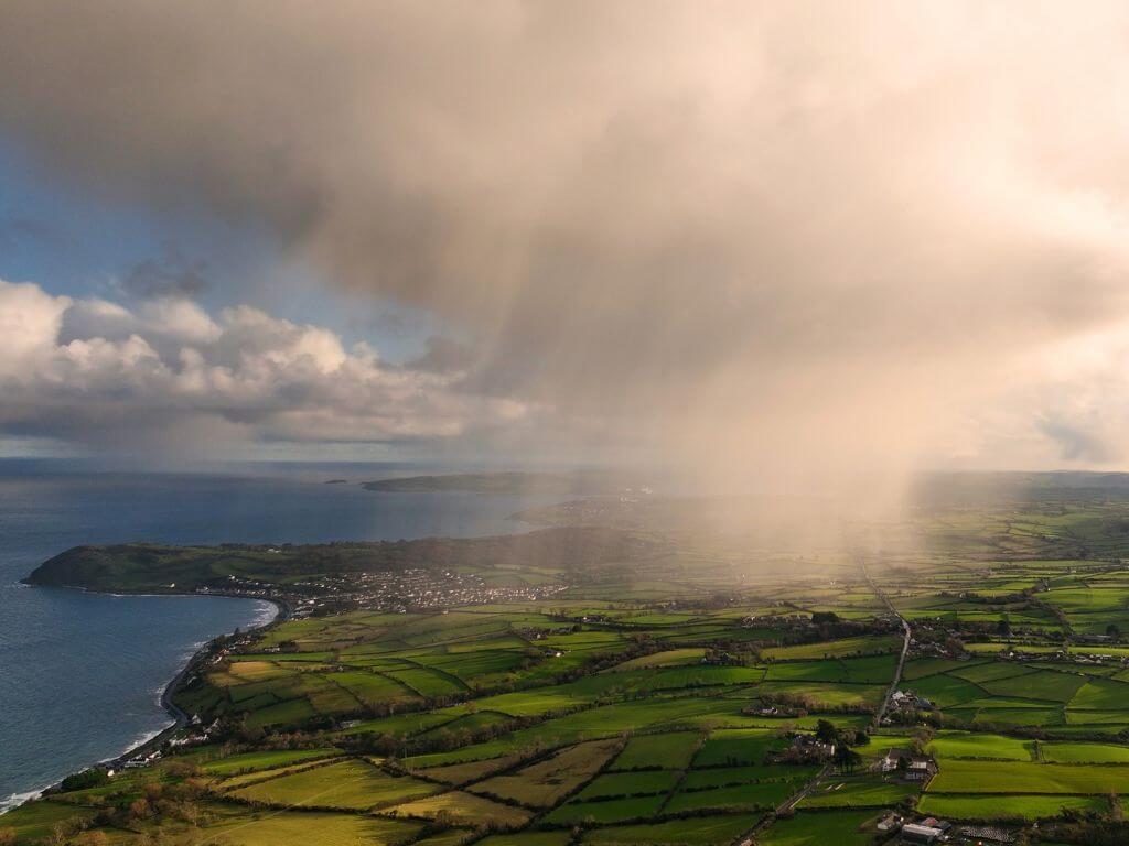 An aerial picture of a rain cloud and downpour over Ballygally in Northern Ireland.