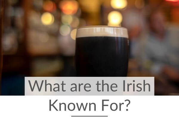 A picture of a pint of Guinness in a pub with the background blurred and text overlay saying what are the Irish known for