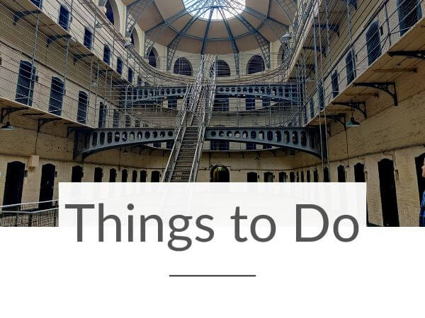 A picture of the famous irson staircase in Kilmainham Gaol, Dublin with text overlay underneath saying Things to Do in Ireland