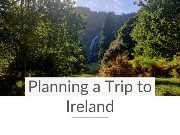 A picture of Powerscourt Waterfall through green trees and text overlay underneath saying Planning a Trip to Ireland