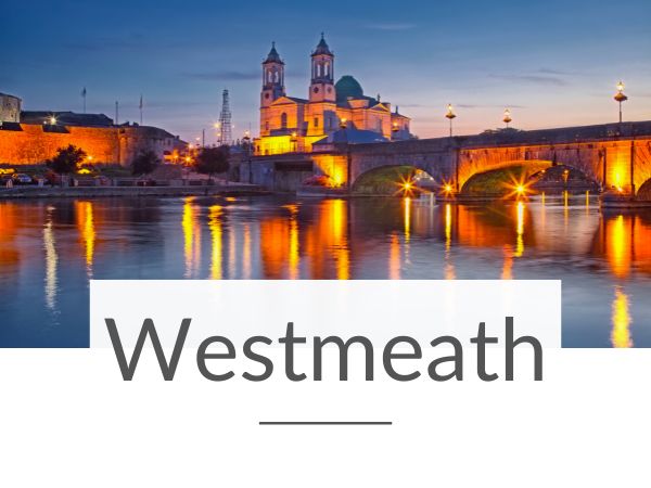 A picture of Athlone by night with the River Shannon in the foreground and text overlay underneath saying Westmeath