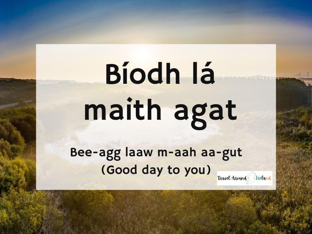 A picture of a sunrise and text overlay saying Bíodh lá maith agat