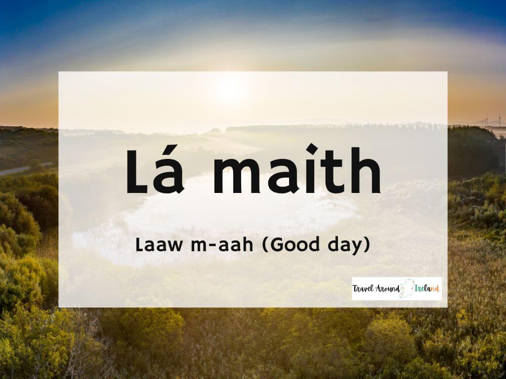 A picture of a sunrise and text overlay saying Lá maith