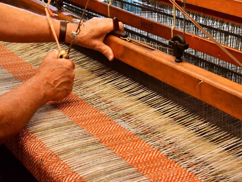 A picture of a man's hands doing hand-weaving in Ardara, Co Donegal, Ireland