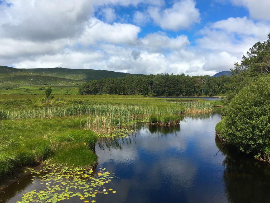 A picture of a lake in Glenveagh National Park, Donegal with some hills and mountains in the background