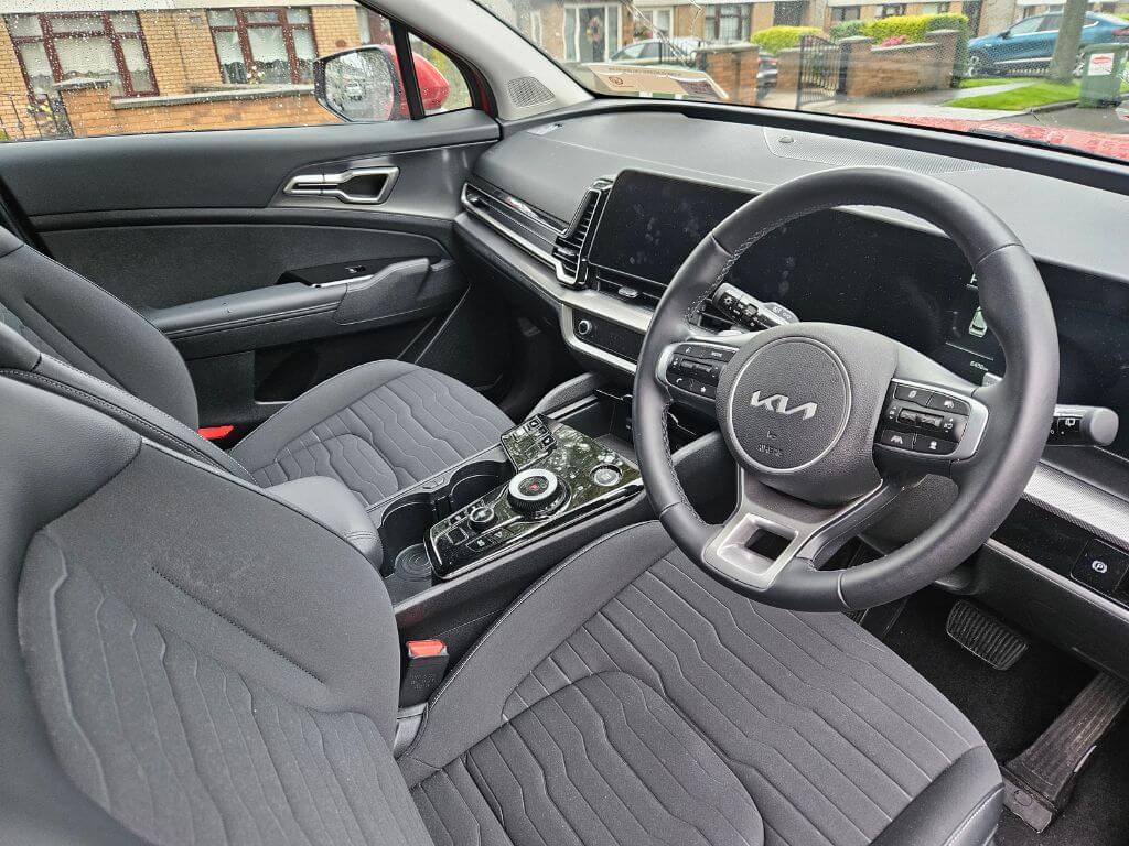 A picture of the front interior of the Kia Sportage rental car.