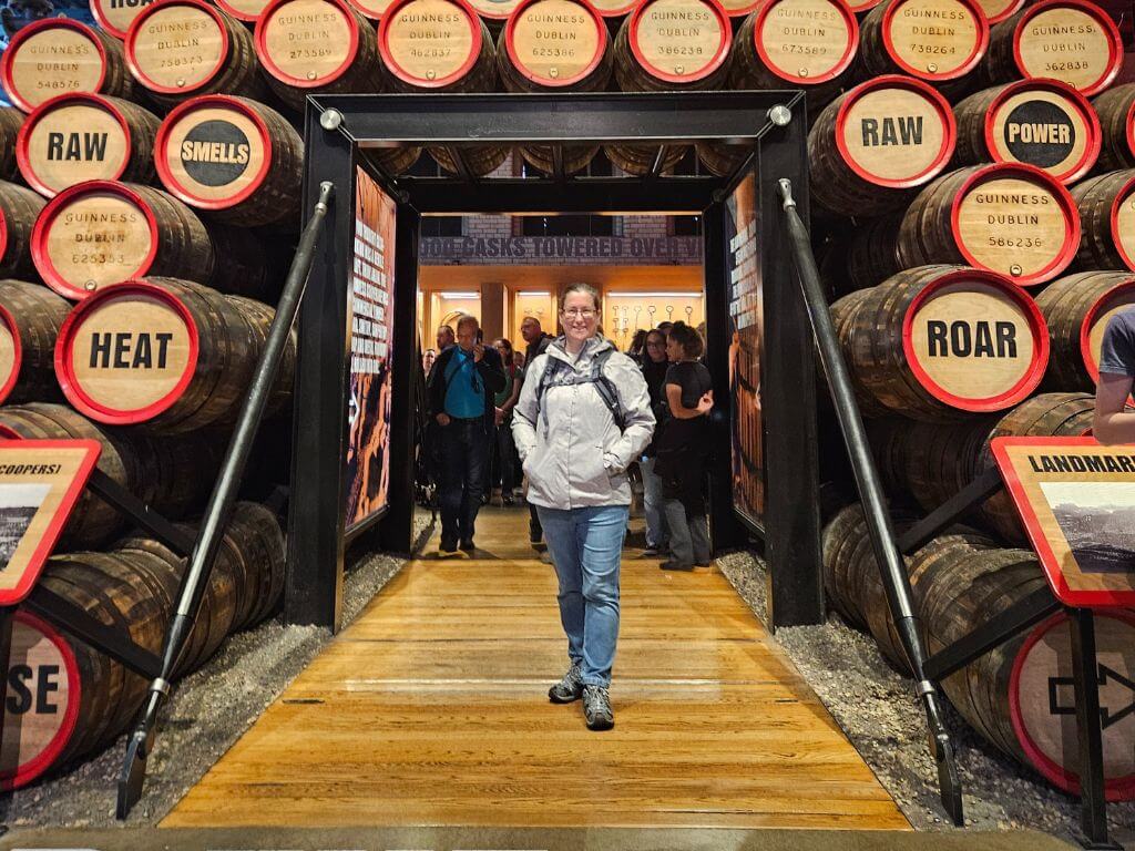 A picture of the author of the website, Travel around Ireland, standing underneath an exhibition of barrels in the Guinness Storehouse in Dublin, Ireland.