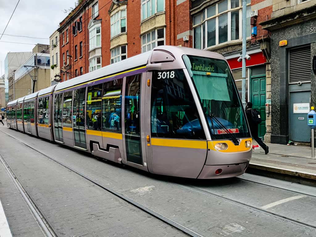 A Luas Red Line tram bound for Tallaght stopped at the platform on Lower Abbey Street in Dublin City Centre.