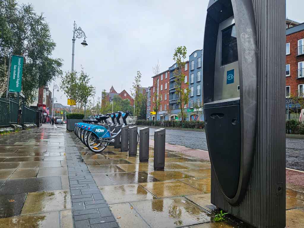 A row of Dublin rental bikes at Christ Church Cathedral in their docking stations and beside the Dublin Bikes payment machine.