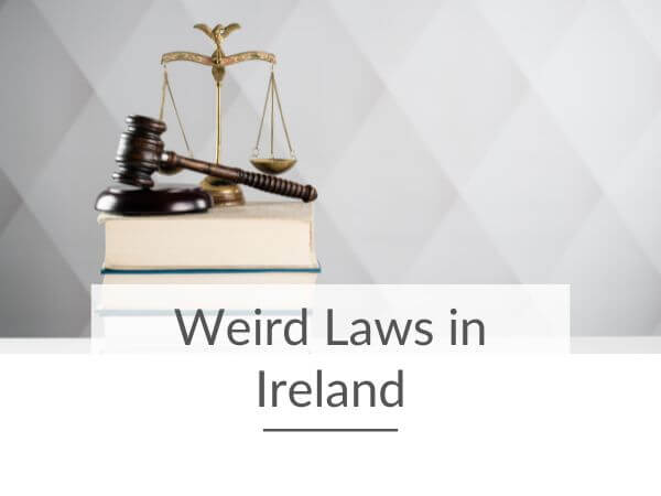 A picture of a scales and court room hammer sitting on some thick books in front of a light background and with text underneath saying weird laws in Ireland.