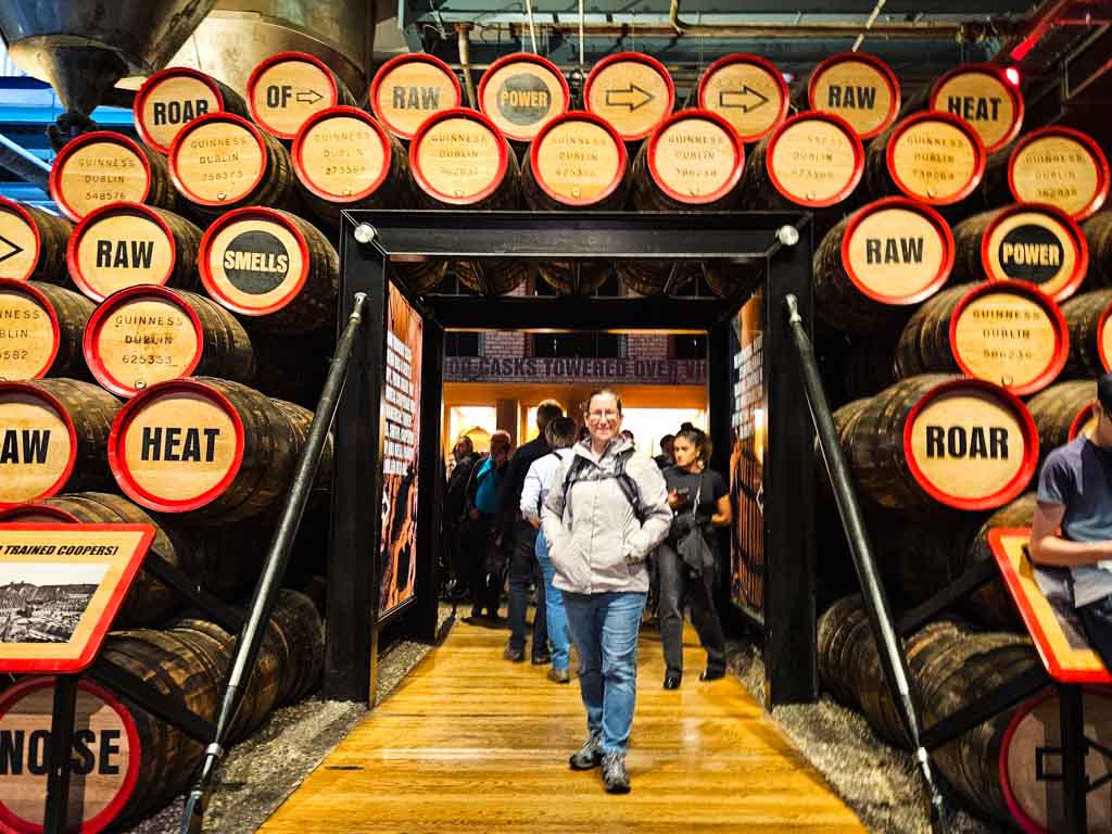 Cath Jordan, author of Travel Around Ireland, at the Guinness Storehouse at the gateway made from barrels with words such as heat, roar and smells on them.