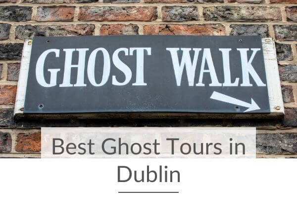 A black and white sign on a brick wall saying ghost walk with an arrow pointing to the bottom right-hand corner and text overlay saying best ghost tours in Dublin.