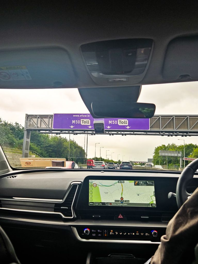 A picture taken from the back seat of a car about to pass under the M50 toll gantry in Dublin.