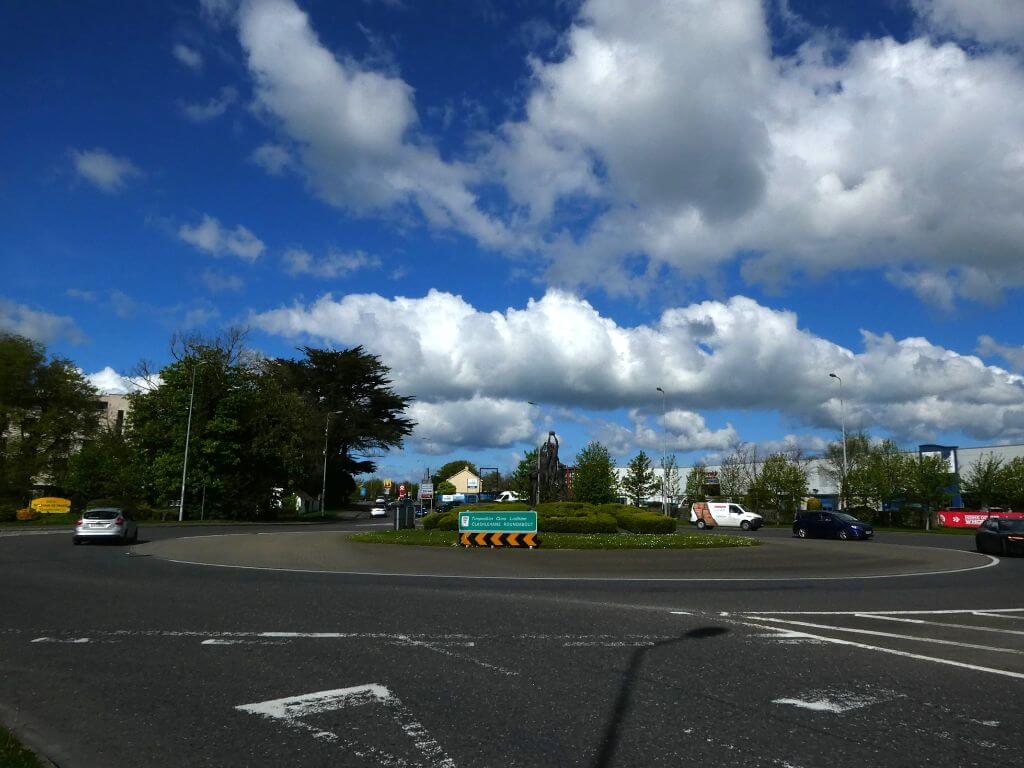 A picture of a roundabout in Tralee, County Kerry, Ireland with blue skies overhead.