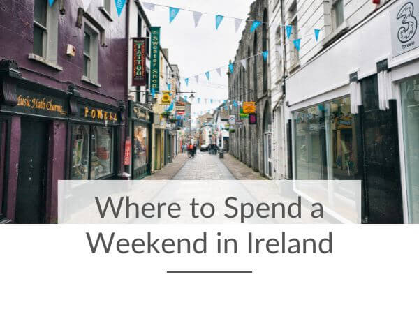 A picture of a street in Galway city with shops on either side and white and blue bunting strung between the buildings and text overlay saying where to spend a weekend in Ireland.