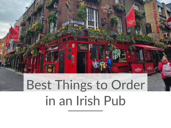 A picture of the Temple Bar pub in Dublin with text overlay underneath saying best things to order in an Irish pub.