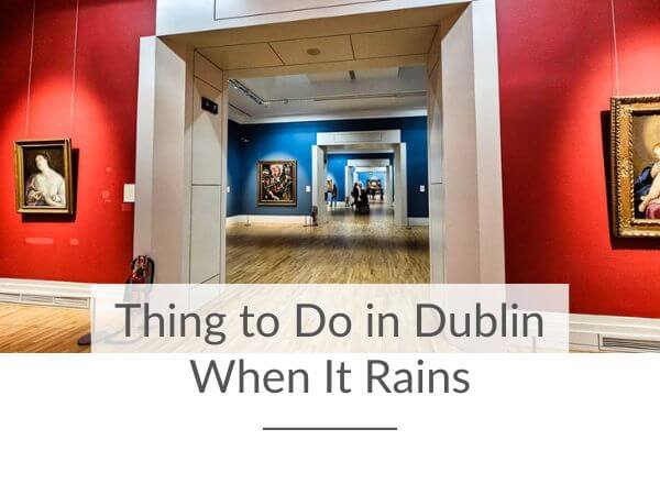 A picture of a red and blue gallery in the National Gallery of Ireland in Dublin, exhibiting paintings on the vibrant colorful walls.