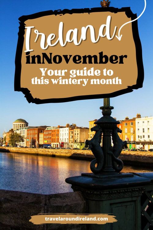 A picture of a riverside light along the River Liffey in Dublin during the month of November. There are blue skies overhead and you can see the top of the Four Courts Building in the distance.