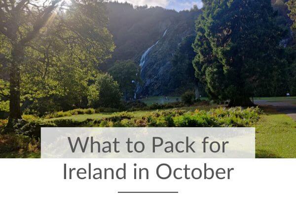 A picture of Powerscourt Waterfall in October through the trees on a clear, sunny day.